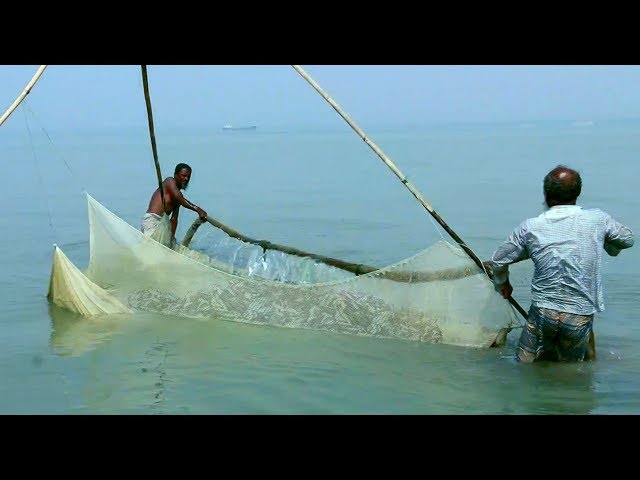 small fish - catching freshwater fish in river - tropical fishing net trap