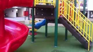 Children Playing In The Park With Roundabouts, Swing, Slide, SeeSaw by JeannetChannel