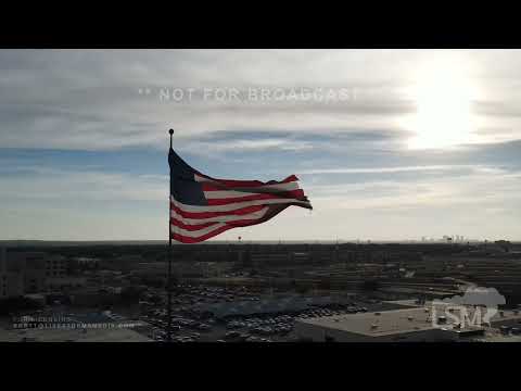 12-23-2021 North Richland Hills, TX - partly cloudy skies & gusty winds light up large American flag