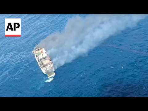 Indonesian rescuers evacuate dozens from a ferry fire that left at least 1 dead near Bali