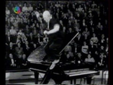 Grock slides off the piano
