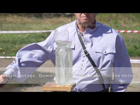 Cossack cuts a plastic bottle with water with a cavalry saber