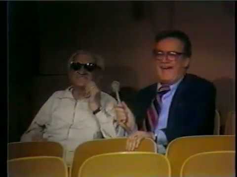 Steve Allen talks to a man sleeping in audience - 1970's