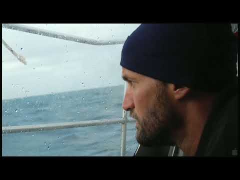180° South trailer still: sailboat crossing Pacific waters at dusk