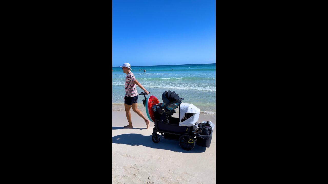 Walking on the beach with 2 kids in Veer Cruiser & Cybex Car Seat