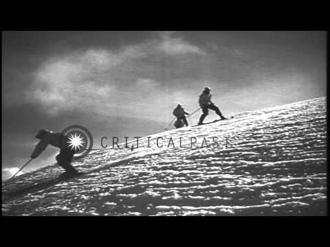 Men sliding downhill and demonstrating the advanced stem turn technique in the Un...HD Stock Footage