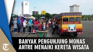 Suasana H+1 Lebaran, Pengunjung Antre Panjang Naik Kereta Wisata di Monas
