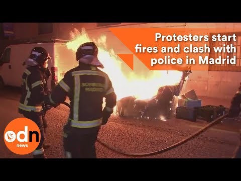 Protesters start fires and clash with police in Madrid