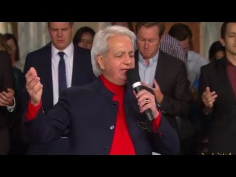 Benny Hinn sings "He's Here Right Now" (Lord We Praise)