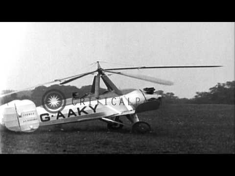 Pilot Juan de la Cierva disembarks autogyro and demonstrates his flight over the ...HD Stock Footage