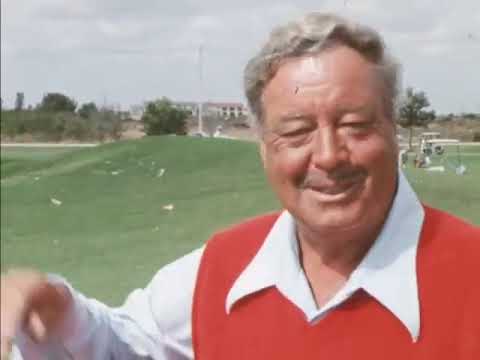 Jackie Gleason showing off his golden golf clubs and customised cart 1976 Florida
