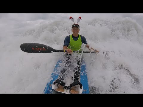 Catching a big wave on a double spec ski. Back paddler disappears