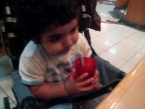 Baby struggling with straw while drinking Pepsi