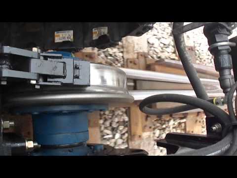 Watch the Video for Cat 324HRE Hydra Guide Rail Gear Travels Through Switch | Mitchell Rail Gear