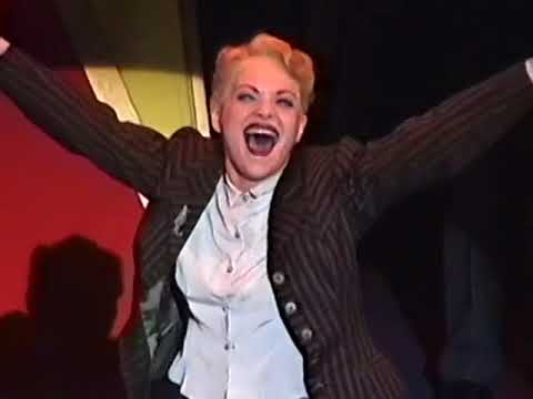 National Theatre clip frame: chorus poised for 'Glamour Dream' as Liza stands center, mirrors behind
