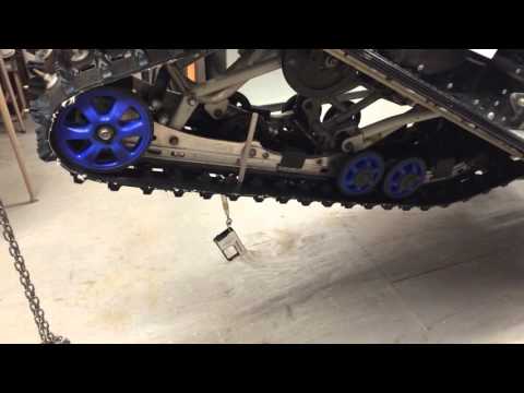 How to adjust track tension on a snowmobile