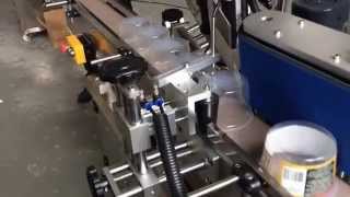 Taper container adhesive labeling machine