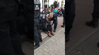 Police carry eco-protester by her neck away from demonstration