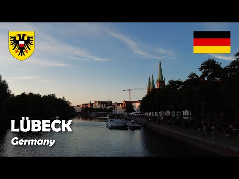 Lübeck, Germany. Walk in the Old Town by the Trave river in sunset. 4K