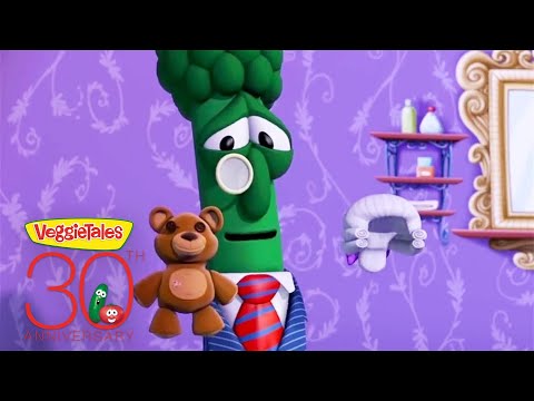 VeggieTales 30th anniversary promo featuring a green broccoli character in a suit and red tie with a teddy bear against a purple patterned wall.
