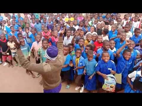 Aprison brass band officer dancing with kids at Bimbi primary  School in Zomba ,Malawi.