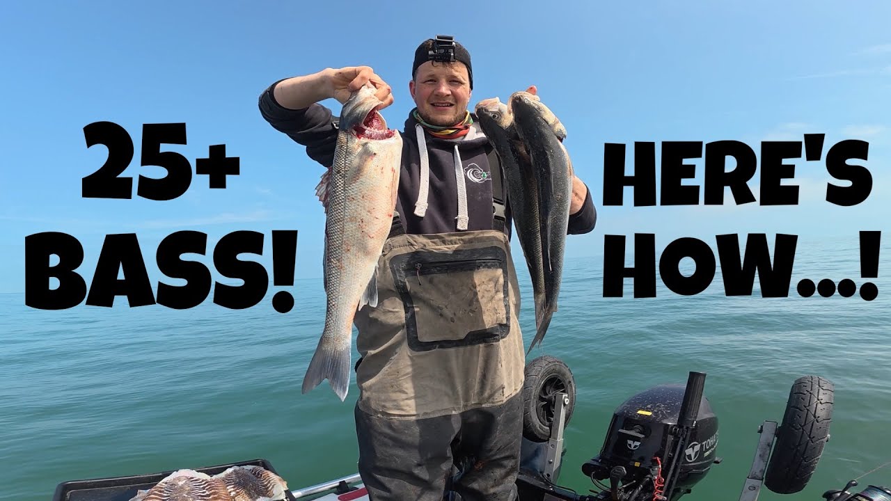 Angler stood on a Hydrus SIB holding two fish up in the air. smile on face