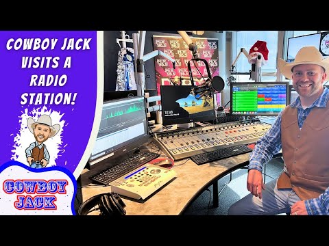 Smiling man in a cowboy hat and vest sits in a radio station studio with mixers and screens; banner reads "Cowboy Jack Visits a Radio Station".
