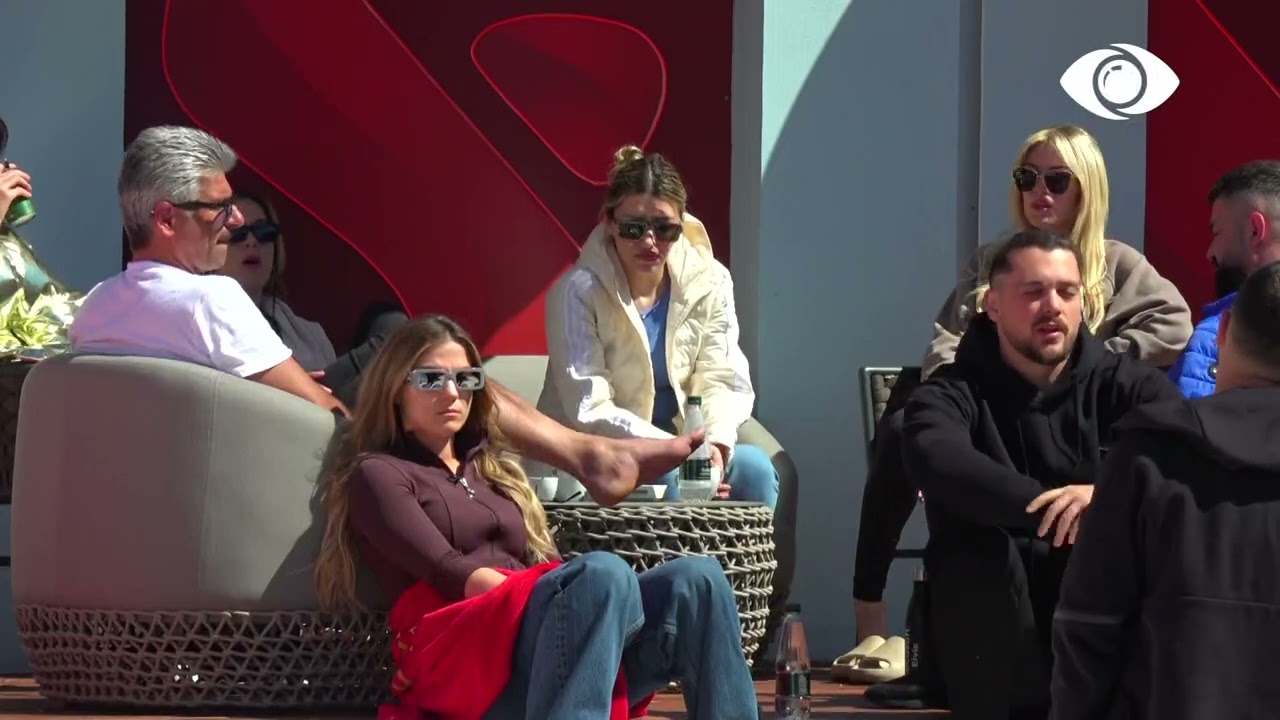 Banorët pinë kafen e mëngjesit dhe bisedojnë në oborr