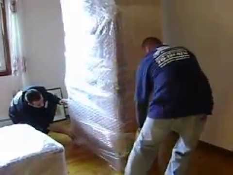 Reliable Movers wrapping antique furniture for a North Carolina interstate move in 2009
