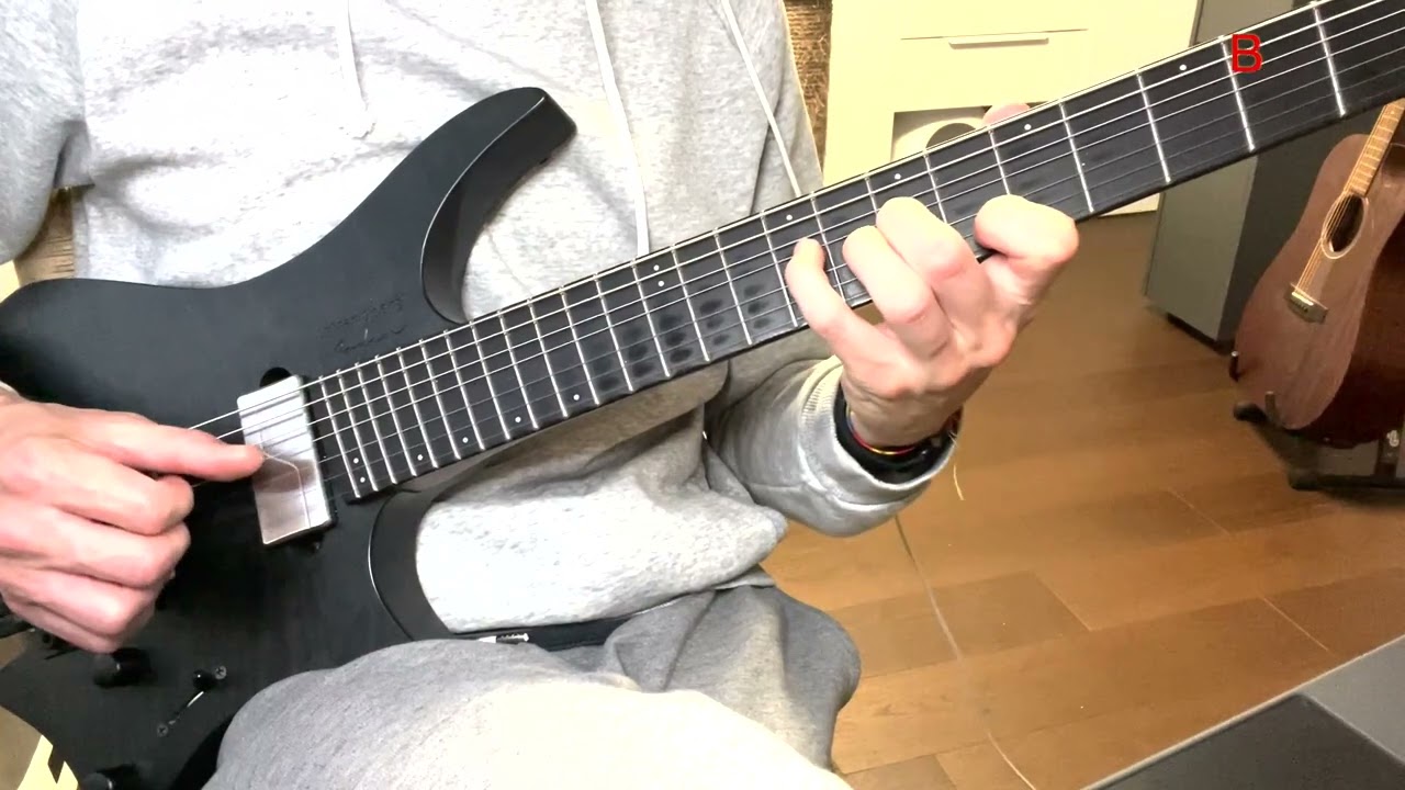 Guitarist demonstrating diminished triads with voice leading on the B, G and D strings
