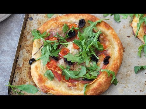 Pizza with Applegate Prosciutto, Tomatoes, Olives and Arugula