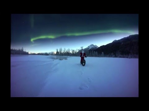 Santa fat biking under the northern lights
