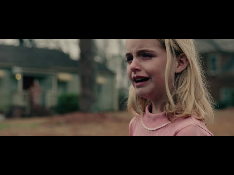 I, Tonya official trailer frame: Tonya in glittering costume mid-jump under TV lights