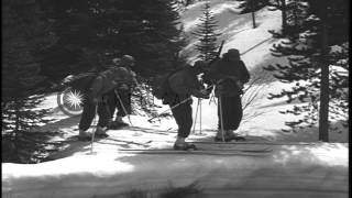 Skiers taking skating steps and arriving near a stream in the United States. HD Stock Footage