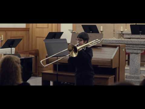 Boy playing "le grand duc" on trombone
