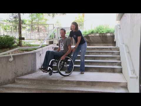 Part of a video titled Craig Hospital Wheelchair Skills: One Person Assist Going Up and Down ...