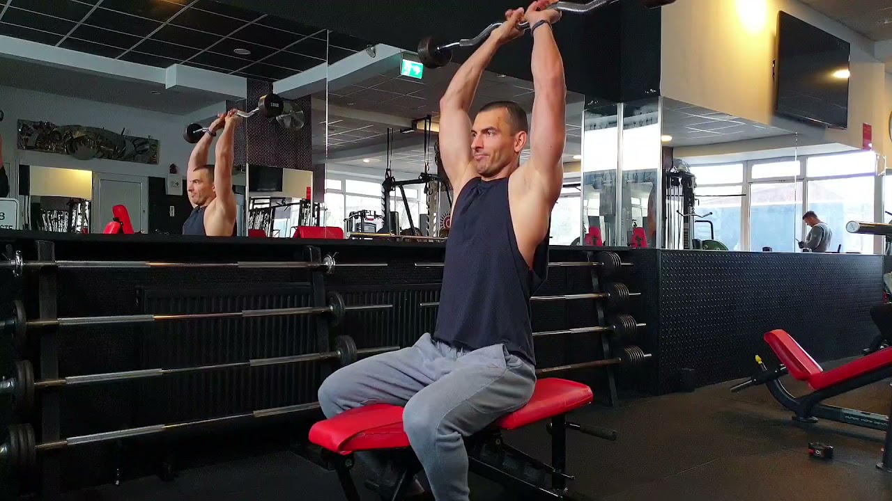 Extensii deasupra capului pentru triceps, din așezat, cu bara Z