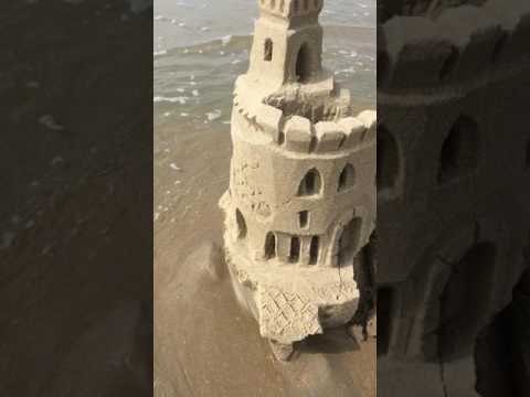 sand castle destruction by tide and waves
