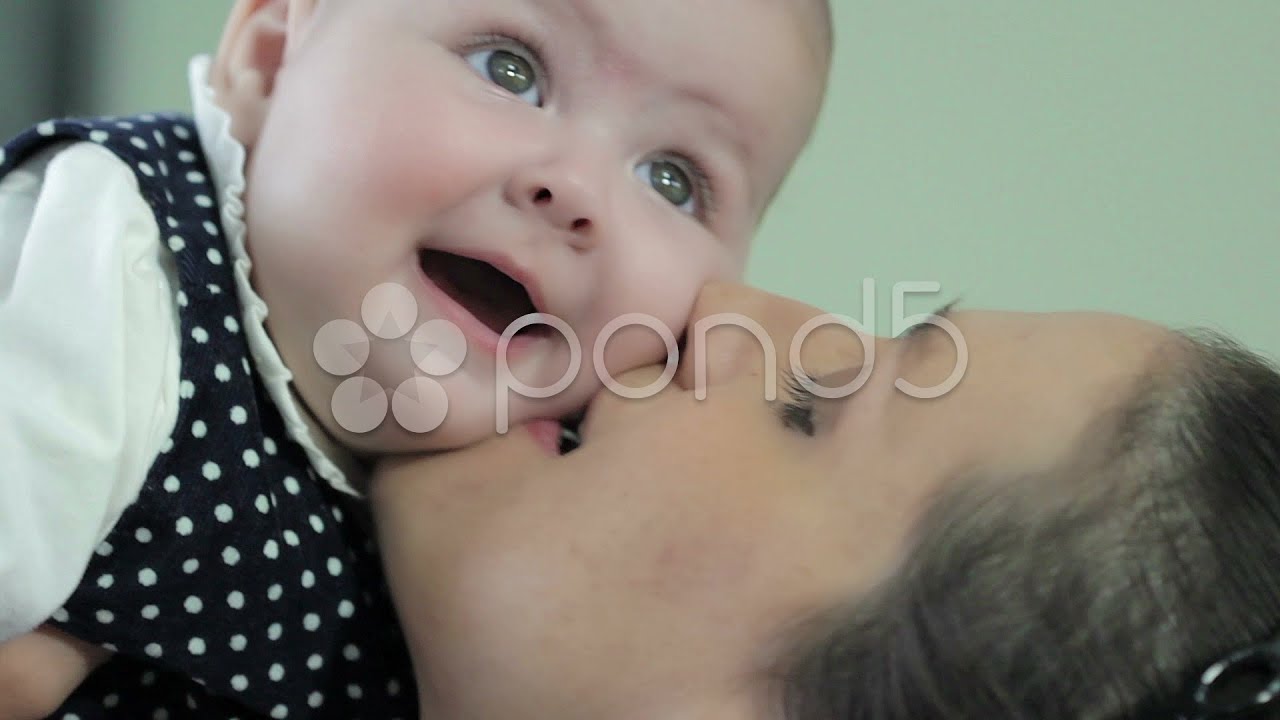 Happy cheerful family. Mother and baby kissing, laughing and hugging. Stock Footage