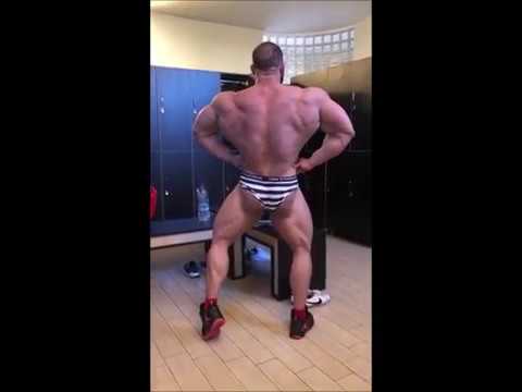 Italian bodybuilder posing in the locker room