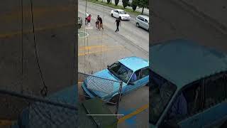 Moment shop worker dives into traffic to save child