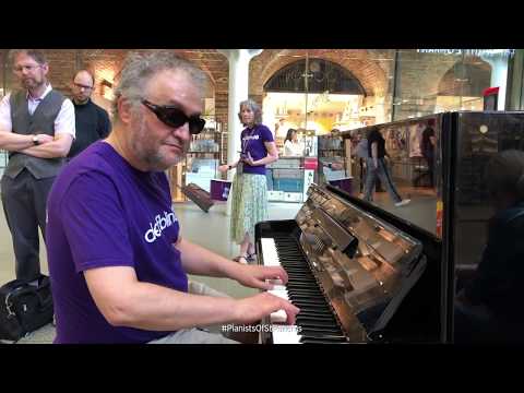 Deafblind UK play the piano at St. Pancras International