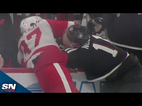 Red Wings' JT Compher Fights Devils' Stefan Noesen After Laying Big Hit On Nico Hischier