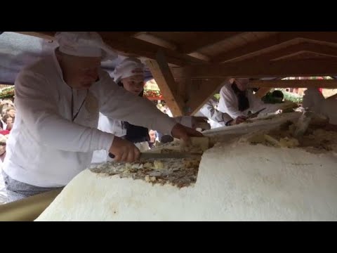 Marching band parades giant Christmas cake at German Christmas market