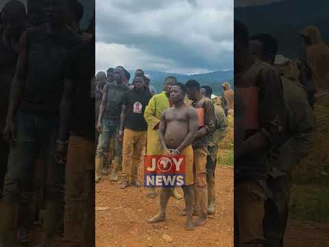 13 suspected illegal miners arrested by NAIMOS are escorted from the Osino site. #JoyNews