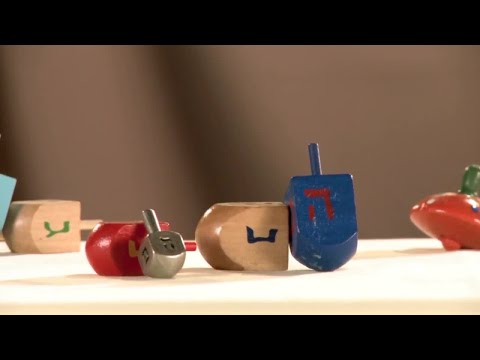 Why do we play dreidel on Hanukkah