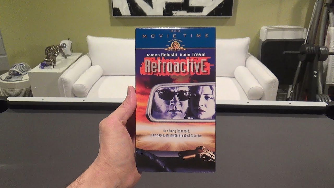 RETROACTIVE 1997 MOVIE REVIEW TIME TRAVEL TIME LOOP MOVIES VHS TAPE TAPES JAMES BELUSHI CRIME FILMS