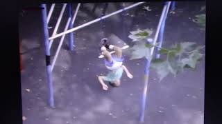 Sesame Street -- A little Boy hanging upside-down with his Knees on a Trapeze