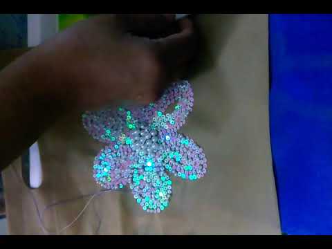 DIY: made a flower with breed and shiny white chumki.