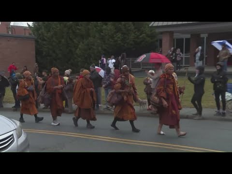 Buddhist monks walk through Triad amid snow conditions